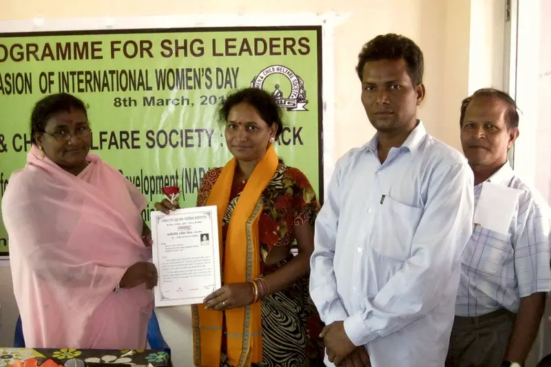 SHG leaders receive certificates at an International Women's Day programme.